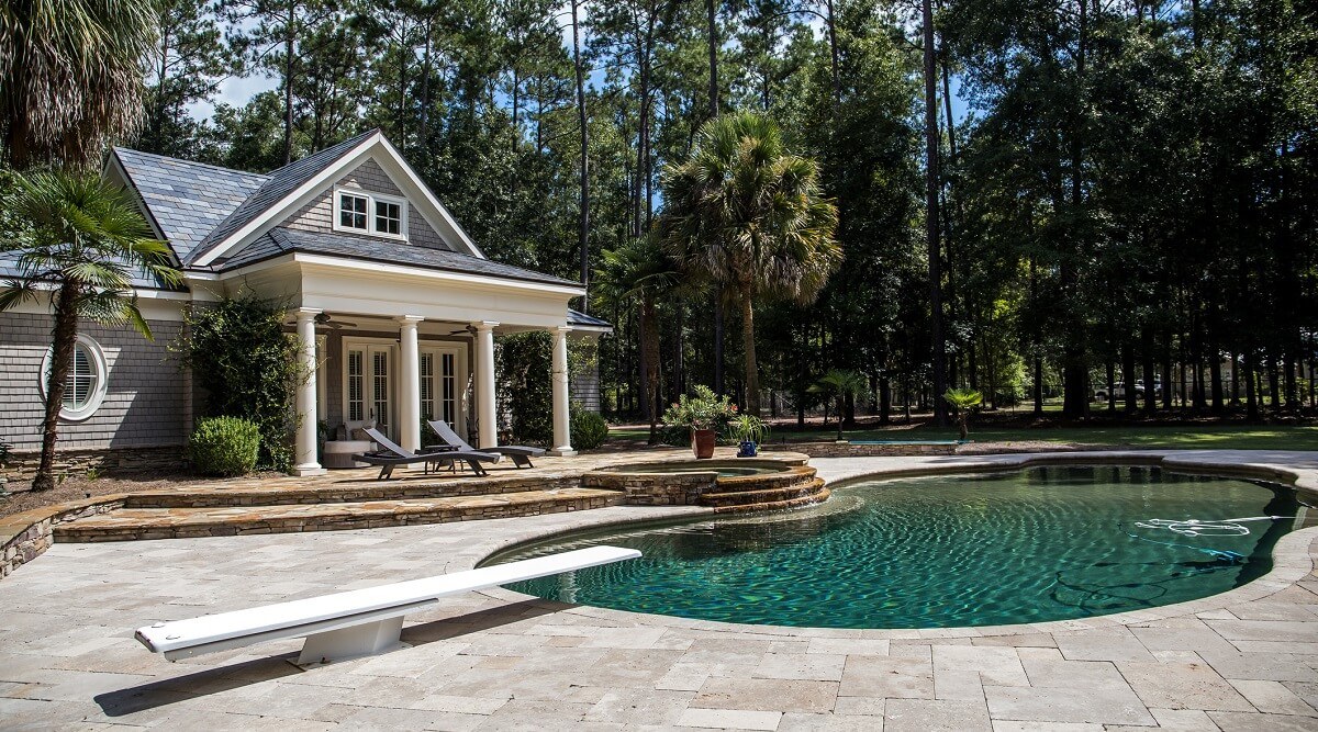 Large home with grotto style pool in backyard.