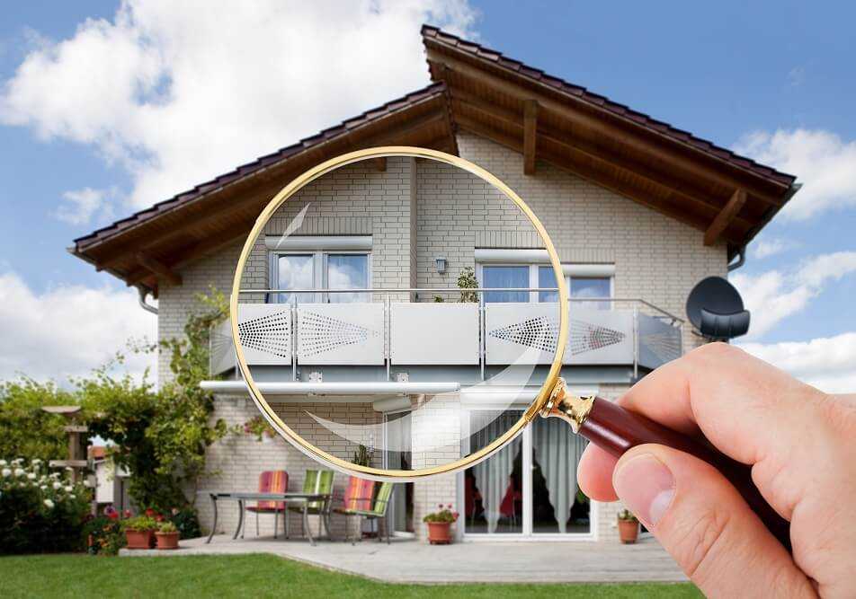 Looking at a home through a magnifying glass.