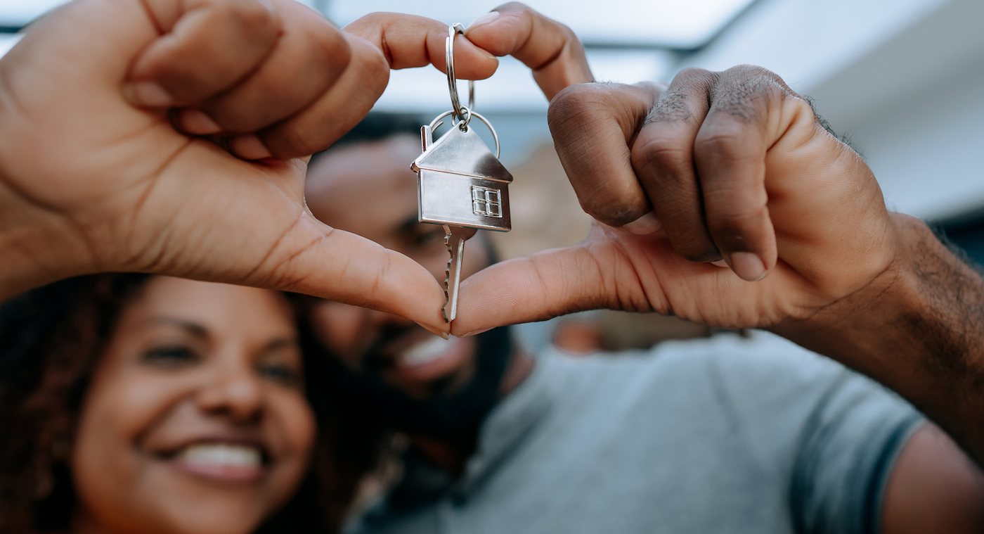 Happy couple receiving key to their second home bought with a VA loan.