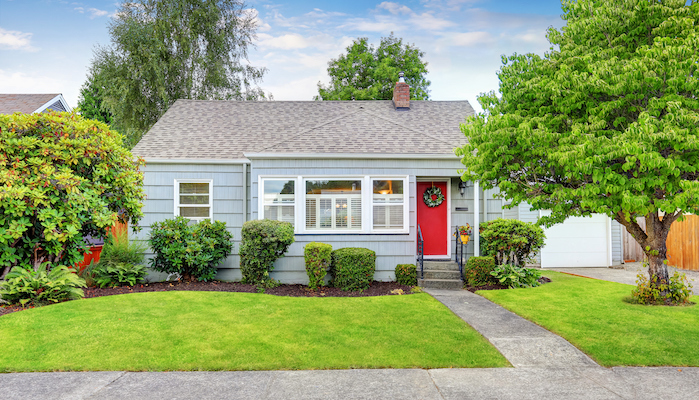 Exterior of small American house with blue paint.