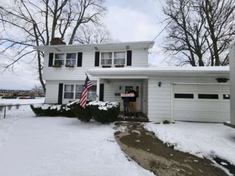 picture of Aaron O. in front of a house