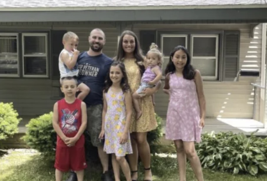 picture of Kirk H. in front of a house